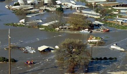 Aerial view of flooded homes and boats

Description automatically generated