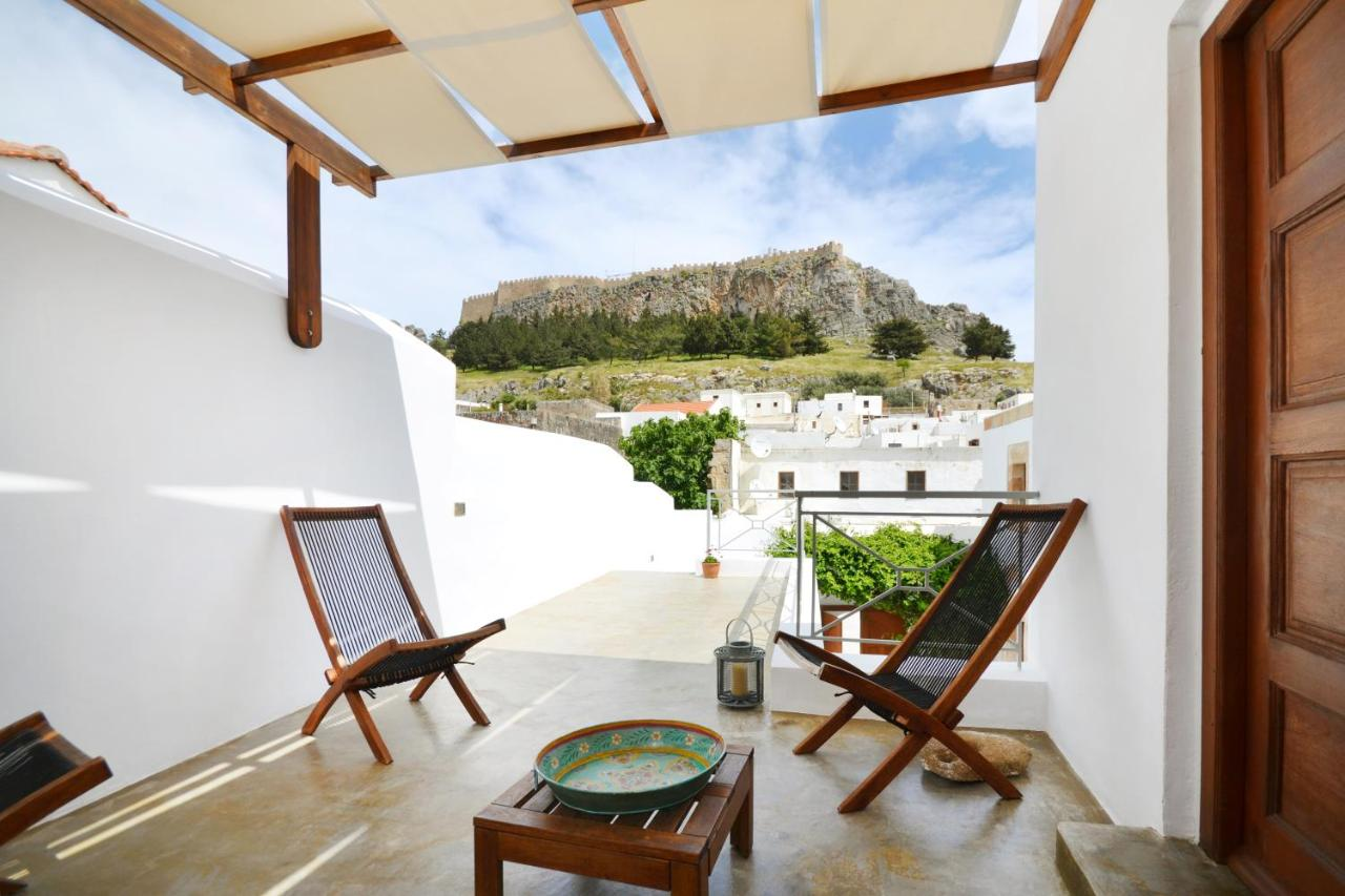 A balcony view at Casa Lindos with chairs where guests can relax the beauty of surroundings.
