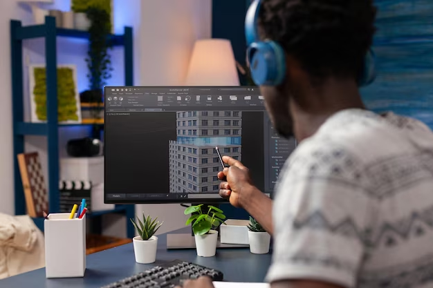 a person looking at the screen which has building model