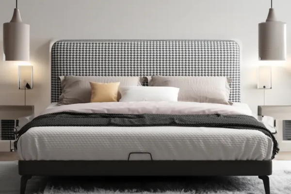 A queen bedframe upholstered in linen, with a patterned headboard and wooden legs.