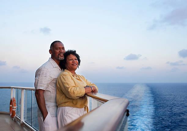couple on deck with cruise ship wake behind them - black lovers stock pictures, royalty-free photos & images