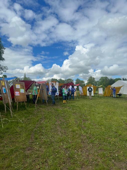 A group of people standing in a field

Description automatically generated