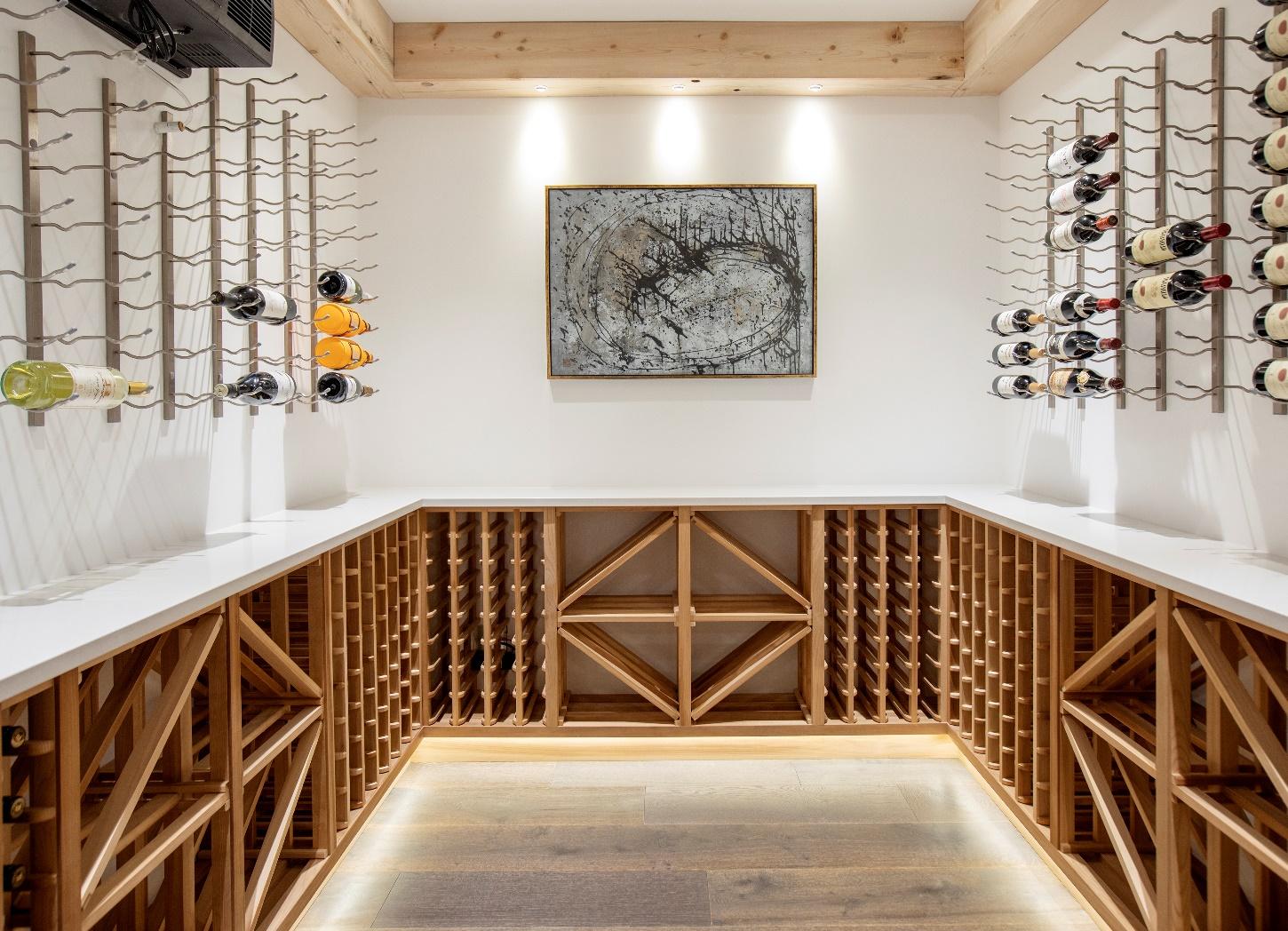 A room with wine racks and a painting on the wall

Description automatically generated