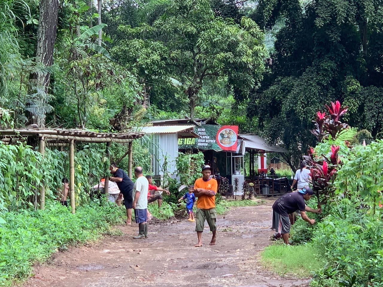 A group of people walking on a dirt road

Description automatically generated