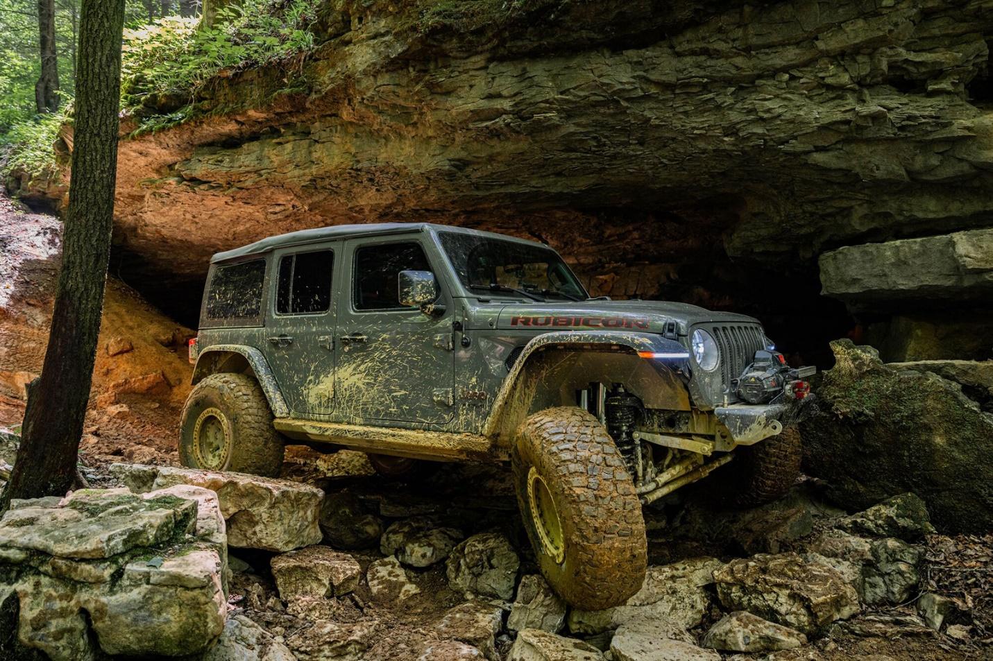 A Jeep driving through a cave
