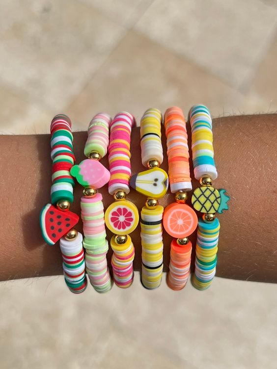 Lady shows off her with different clay beads bracelet