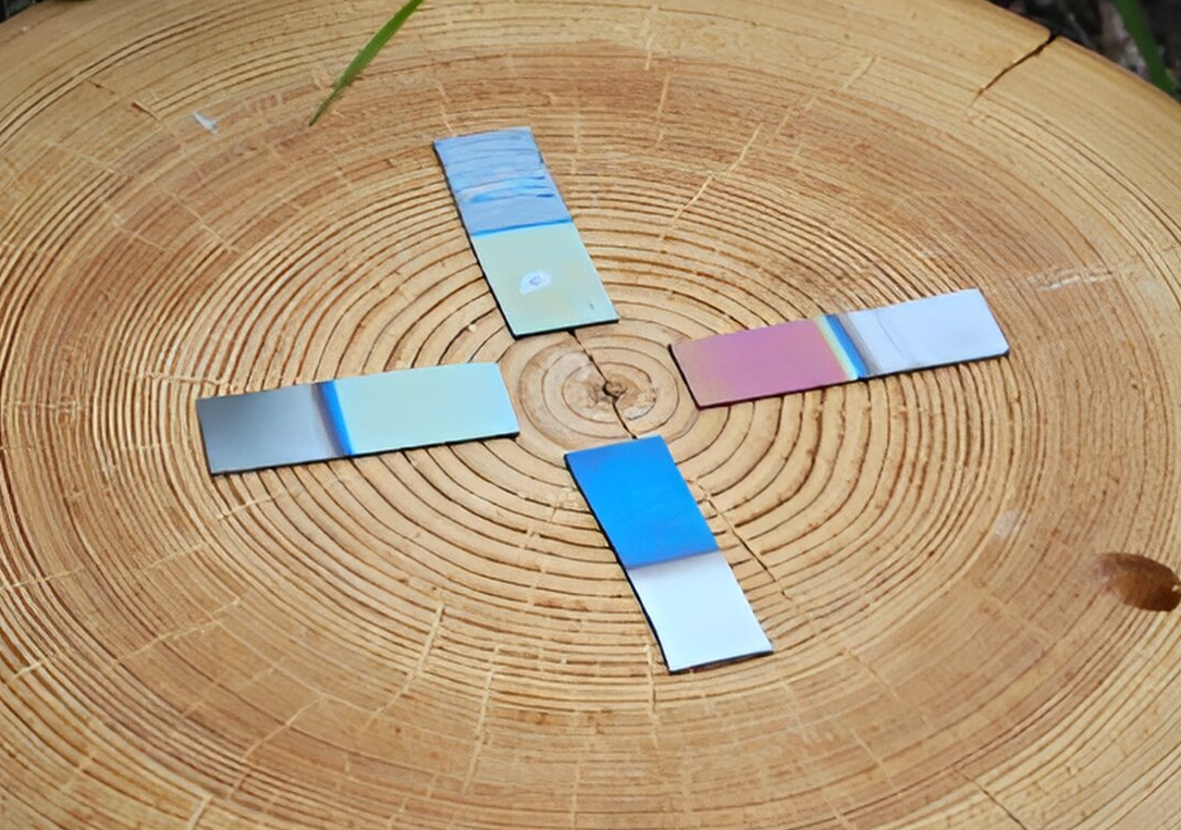 A group of colored strips on a wood surface

Description automatically generated