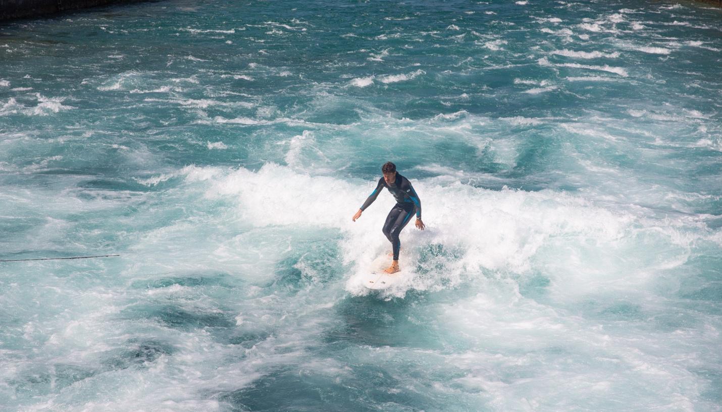 A person surfing in the ocean

Description automatically generated