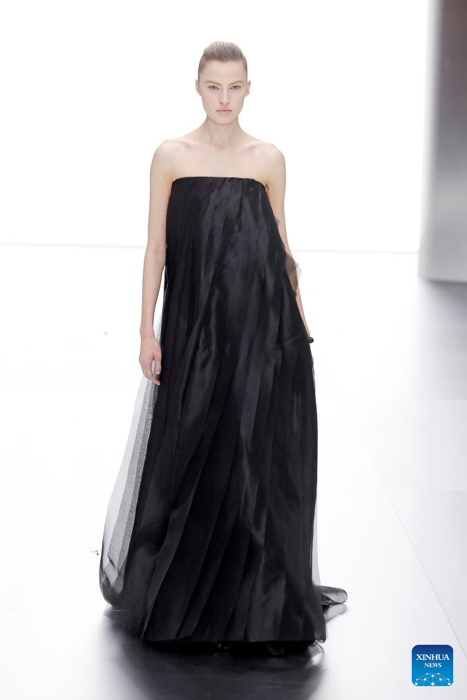 Picture of a model on the runway in a gorgeous black gown for the Fendi show