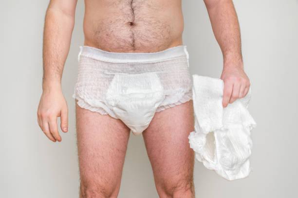 Man wearing incontinence diaper Man wearing incontinence diaper isolated on white men adult diaper stock pictures, royalty-free photos & images
