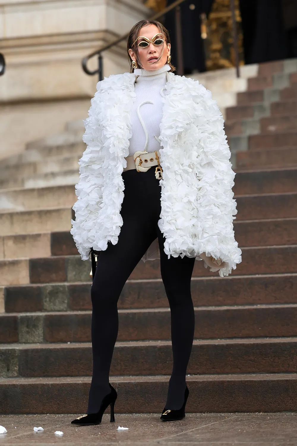 Picture showing Jennifer Lopez in a white ruffled feather coat at the event