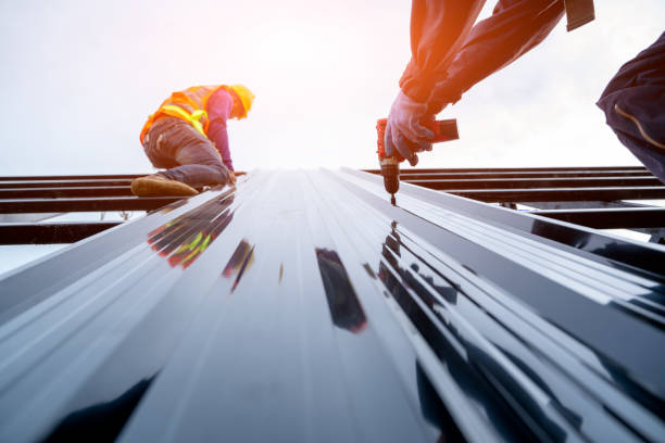 Roofer worker in protective uniform installing asphalt shingle