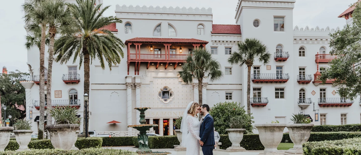 Bride and groom embracing outside of the Casa Monica Resort & Spa in St. Augustine, FL