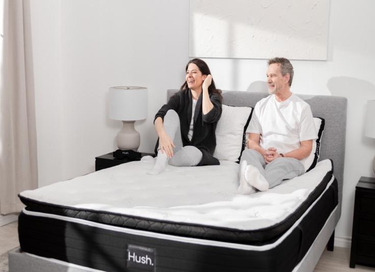 A person and person sitting on a mattress

Description automatically generated