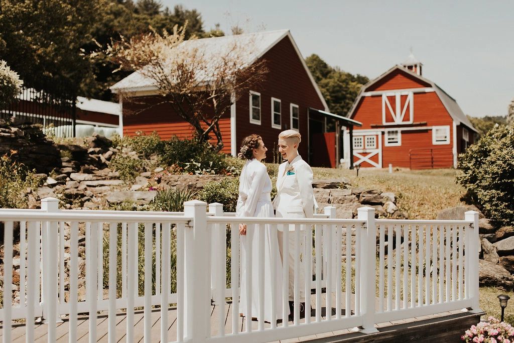 Couple standing on bridge laughing together
