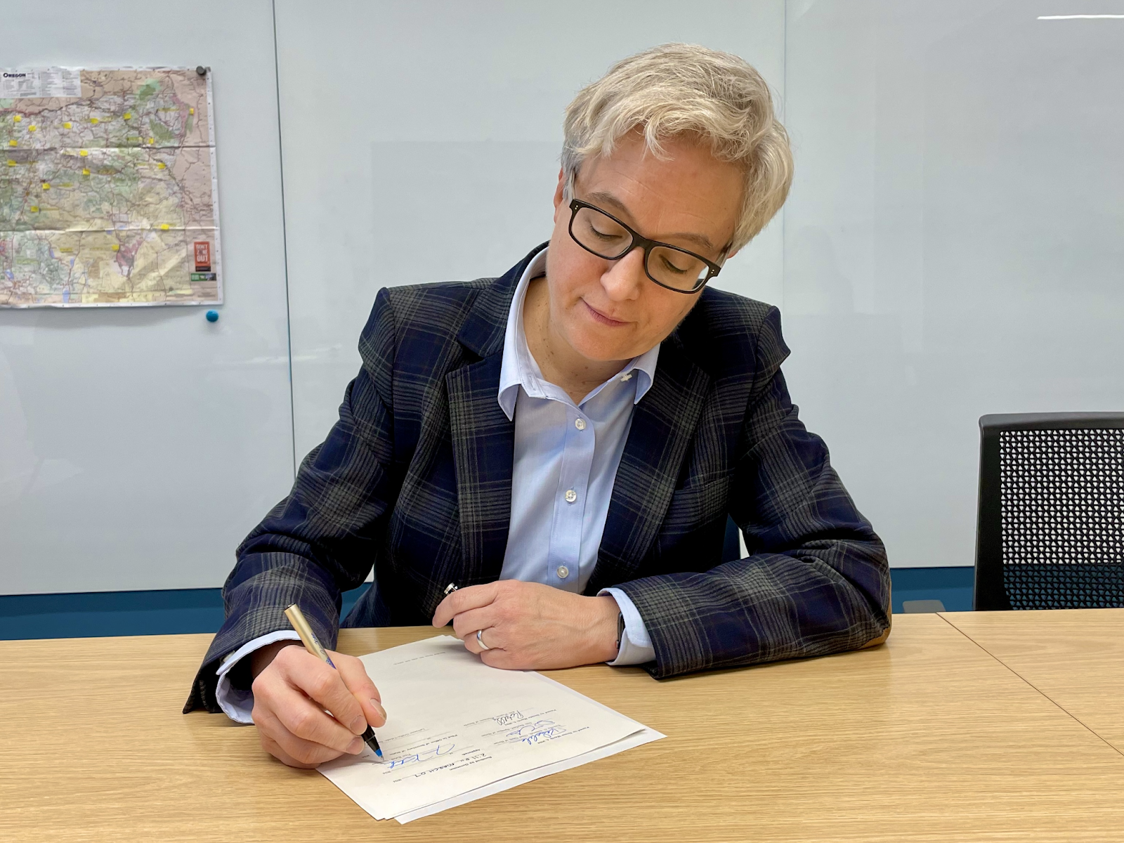 Tina Kotek signing bill into law