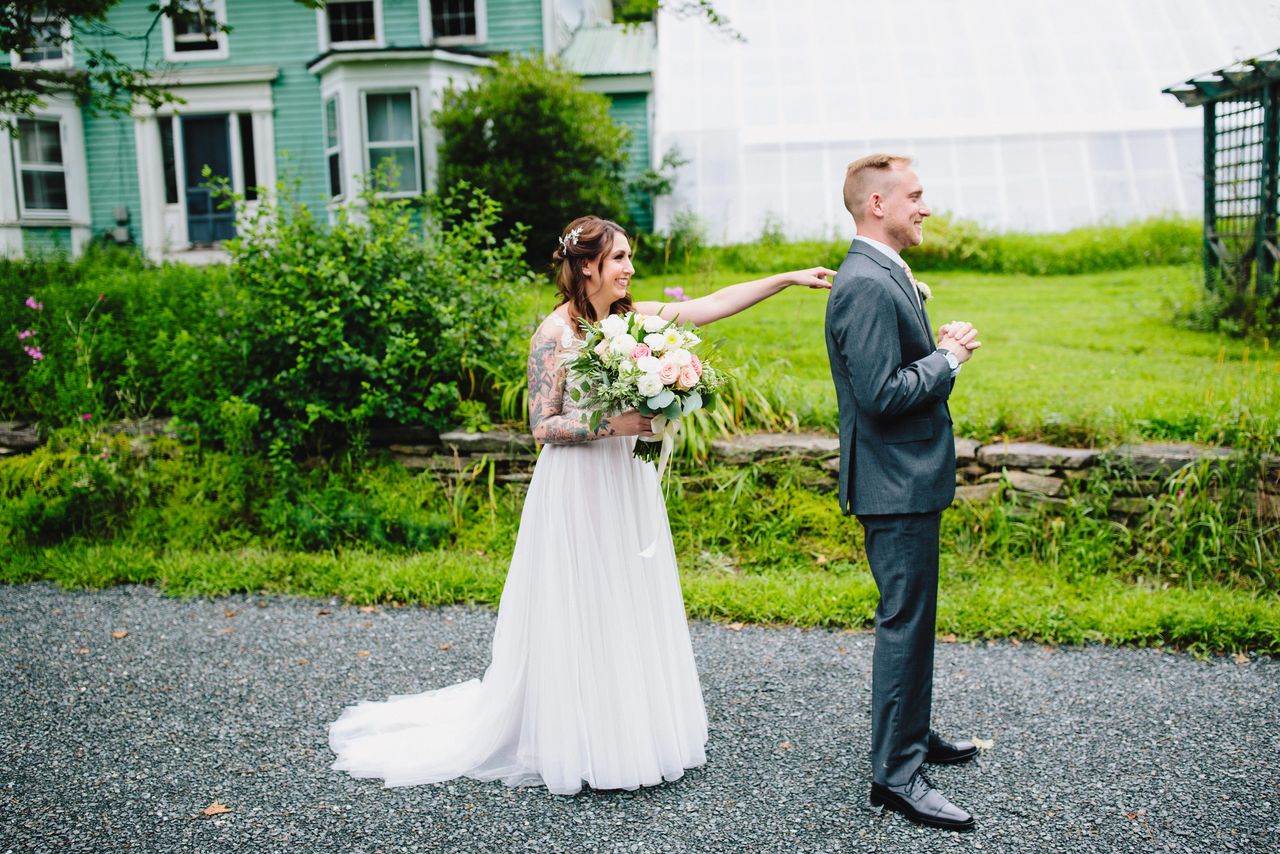 Bride tapping groom on the shoulder