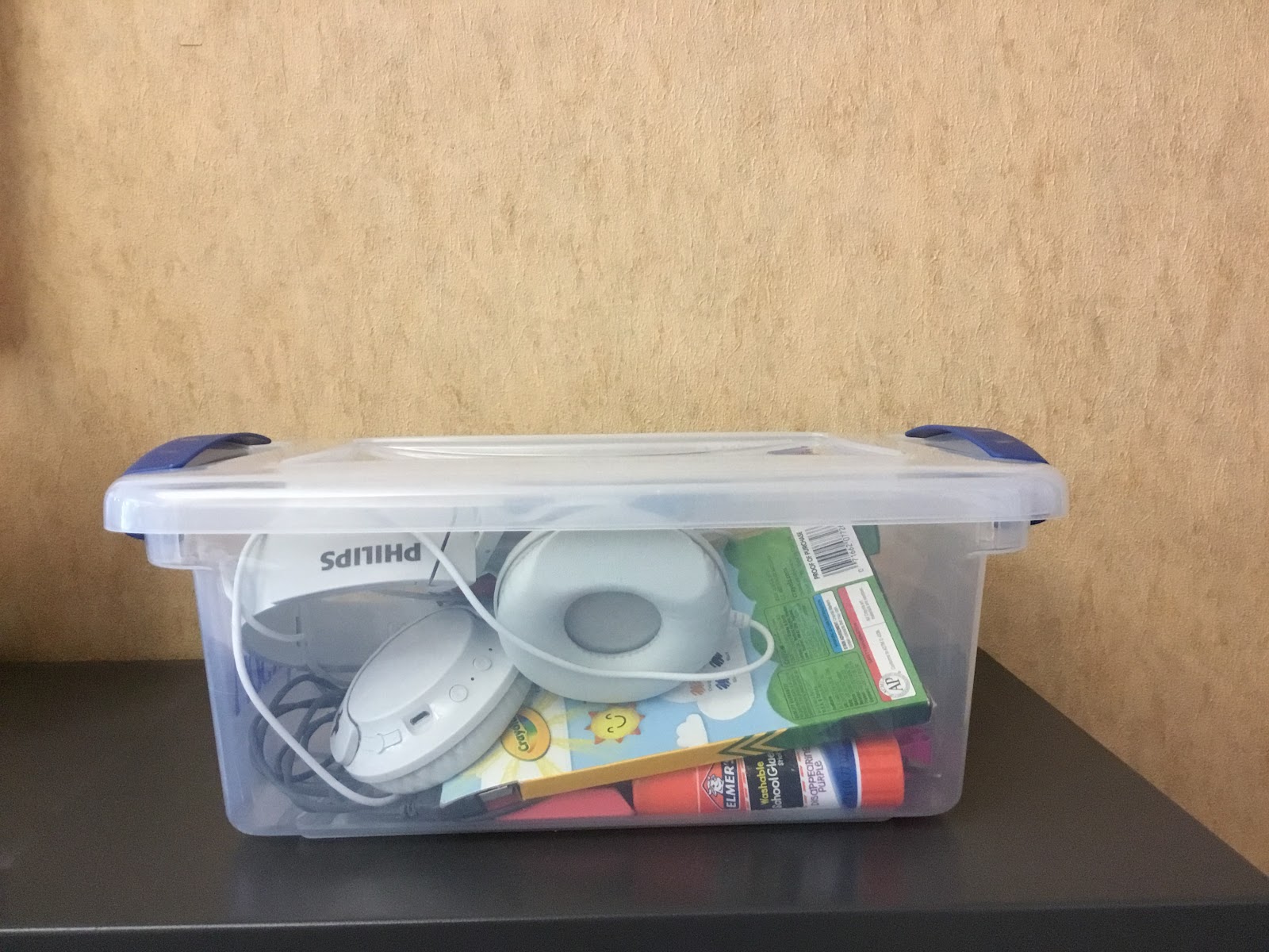 clear plastic container with school supplies in it