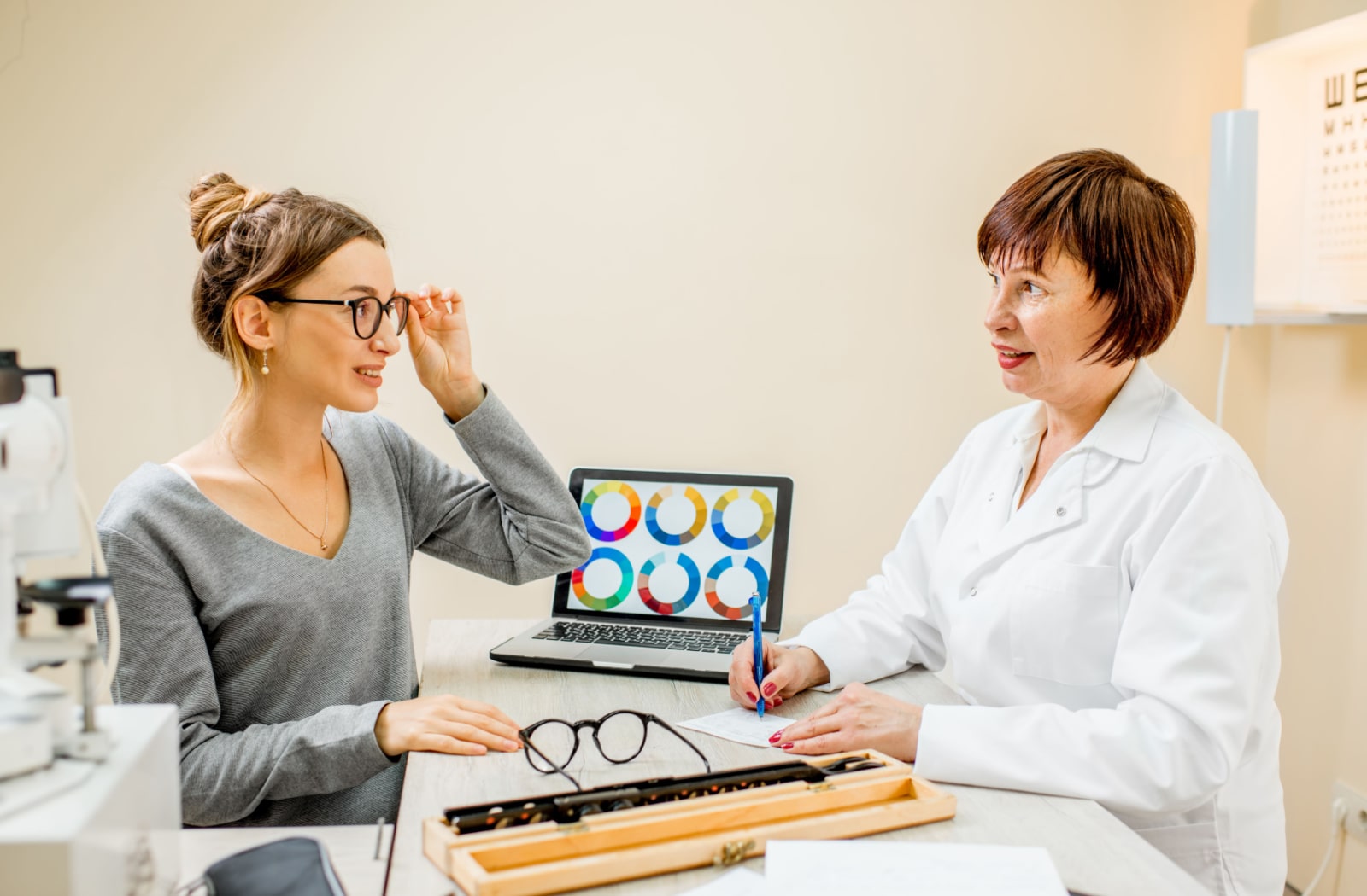 A female optometrist talking to a female patient about colorblindness and her glasses