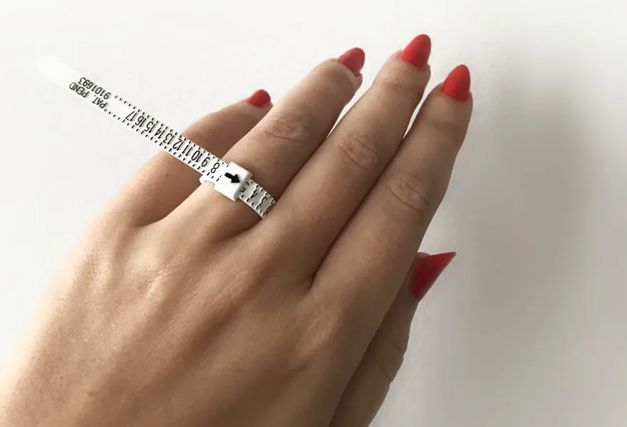 Picture showing a well placed hand trying to measure the ring size