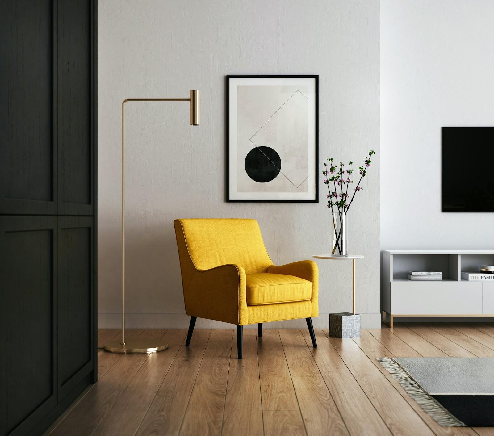 a yellow armchair and a painting on the wall