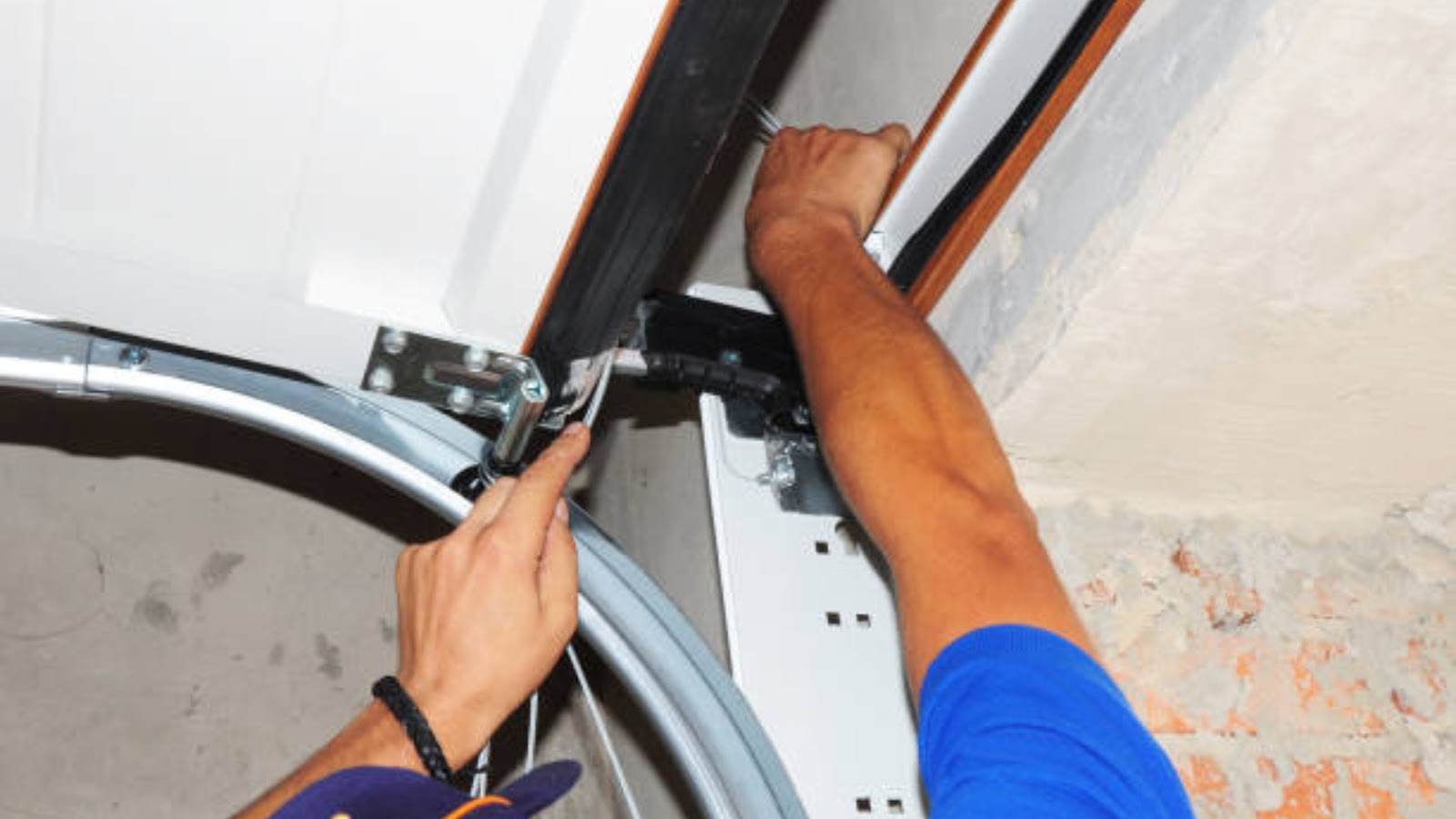 A technician performing a garage door maintenance service
