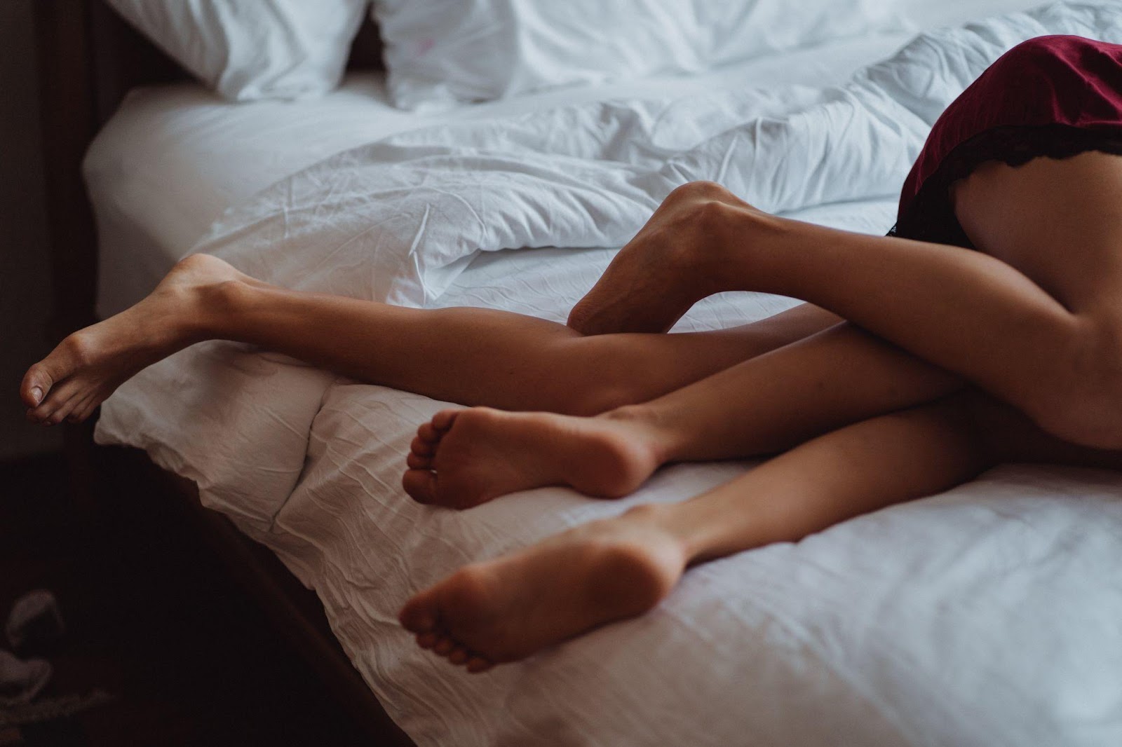 Two people having an intimate moment in bed