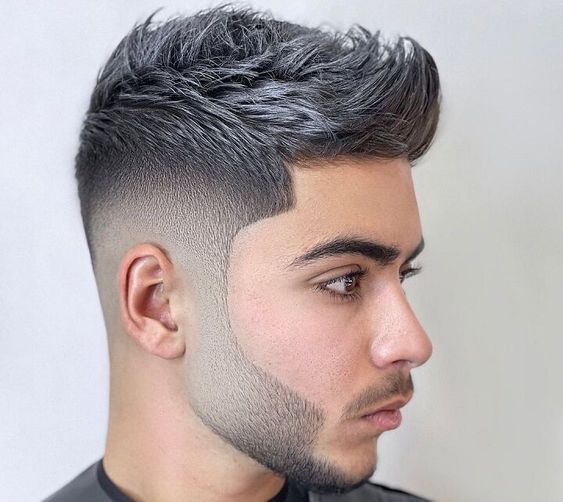 Side view of a guy rocking the iconic quiff