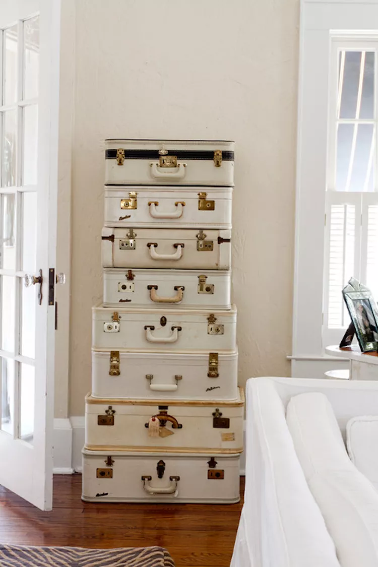 If you adore decor with a consistent color palette, seek vintage suitcases in the same hue. You should stack or arrange the suitcases based on size, placing the larger ones at the bottom.