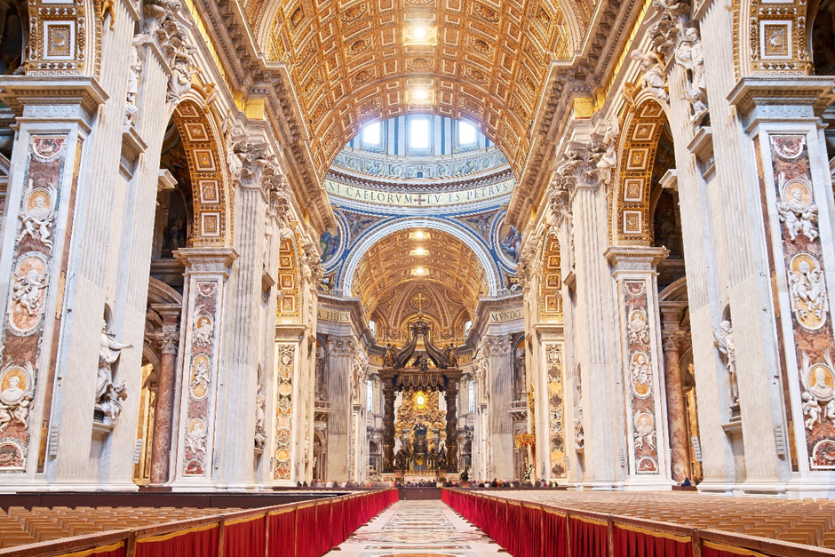 Interior of the Vatican. A large ornate building with columns and a ceiling