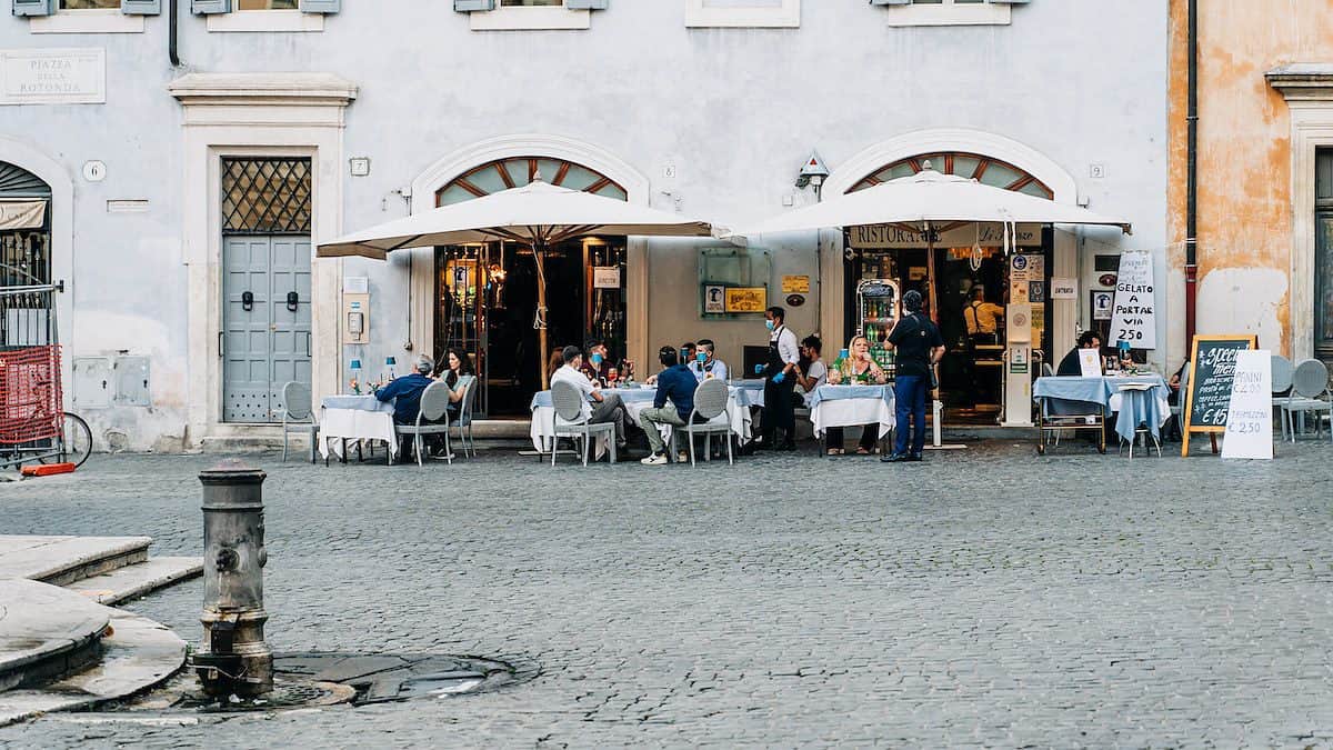 people sitting on chair near building during daytime