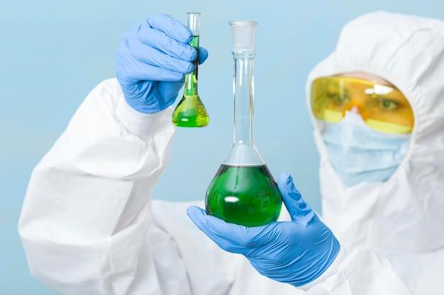 Free photo scientist holding green chemicals