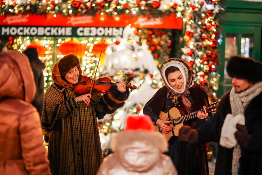 A group of people playing instruments in a street

Description automatically generated