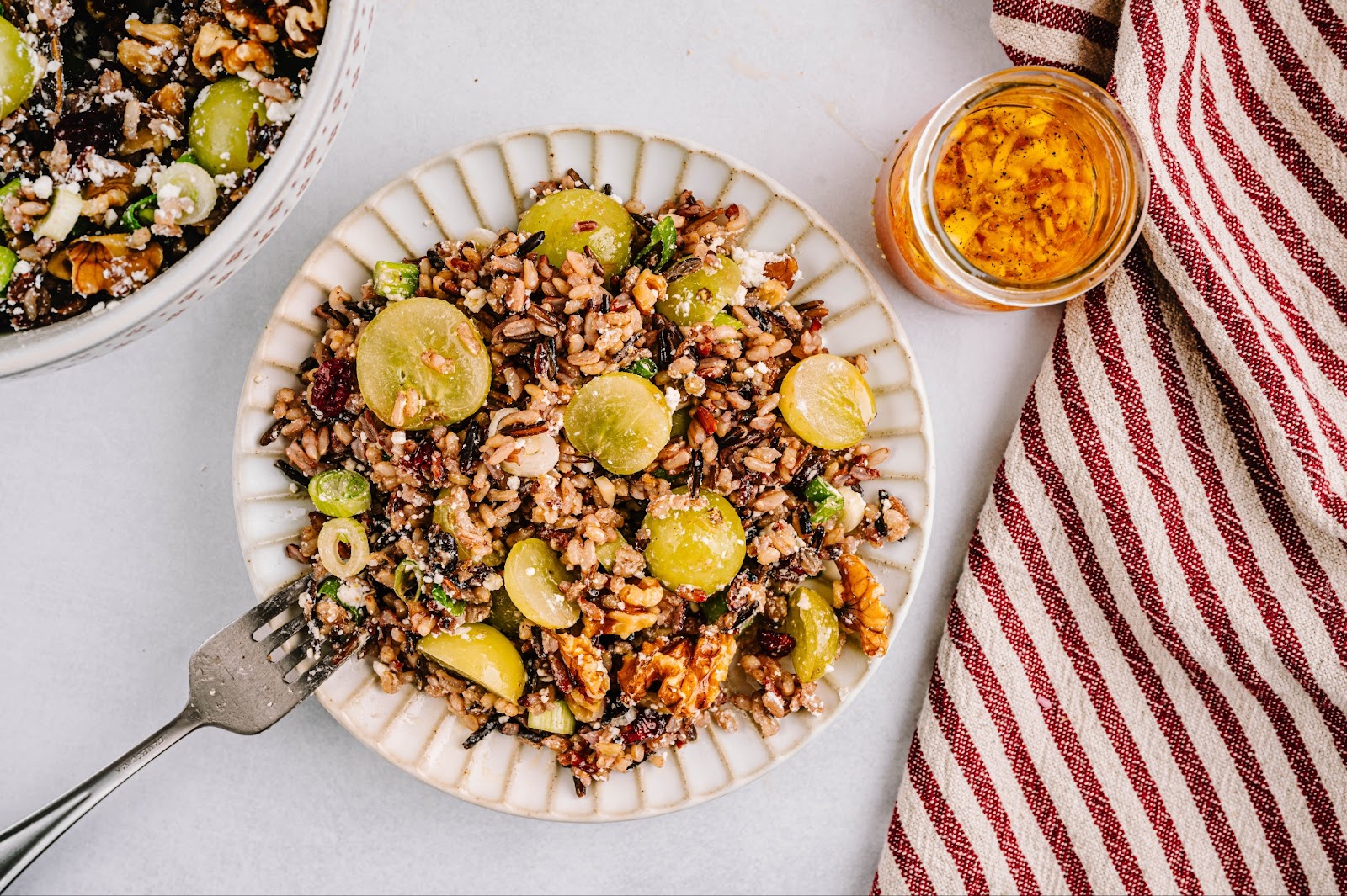 Wild rice salad on a plate with dressing.