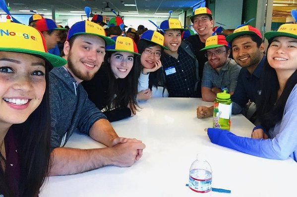 A group of new hires at Google wearing their Noogler hats
