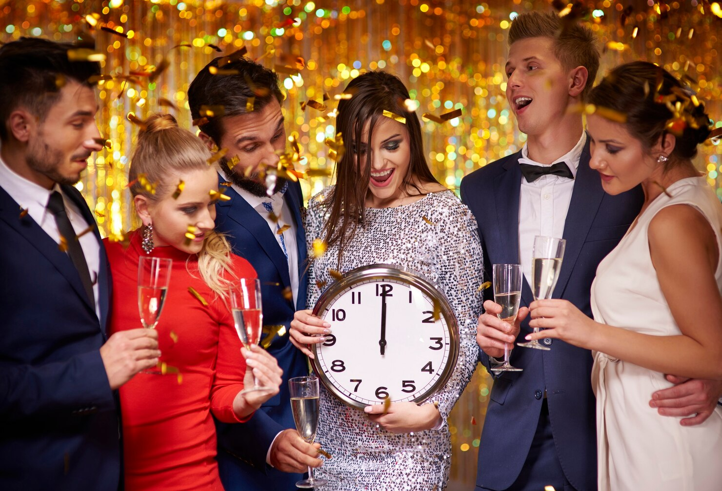 Friends celebrating new year as the clock strikes 12.