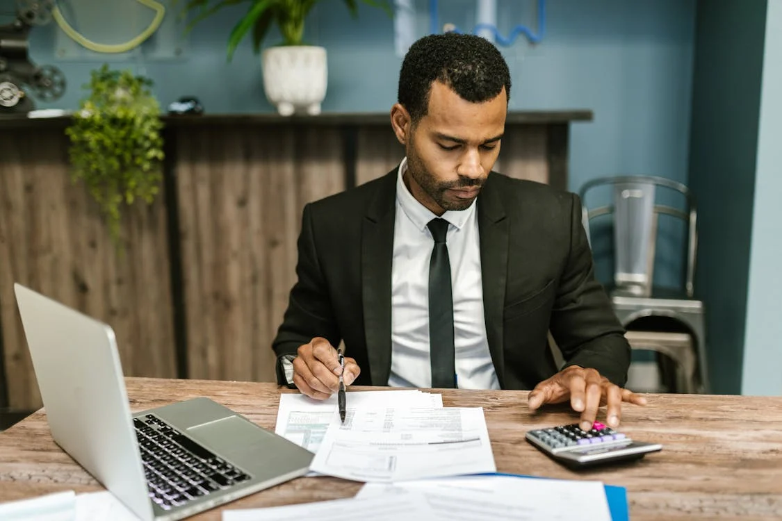 man in suit calculating expenses