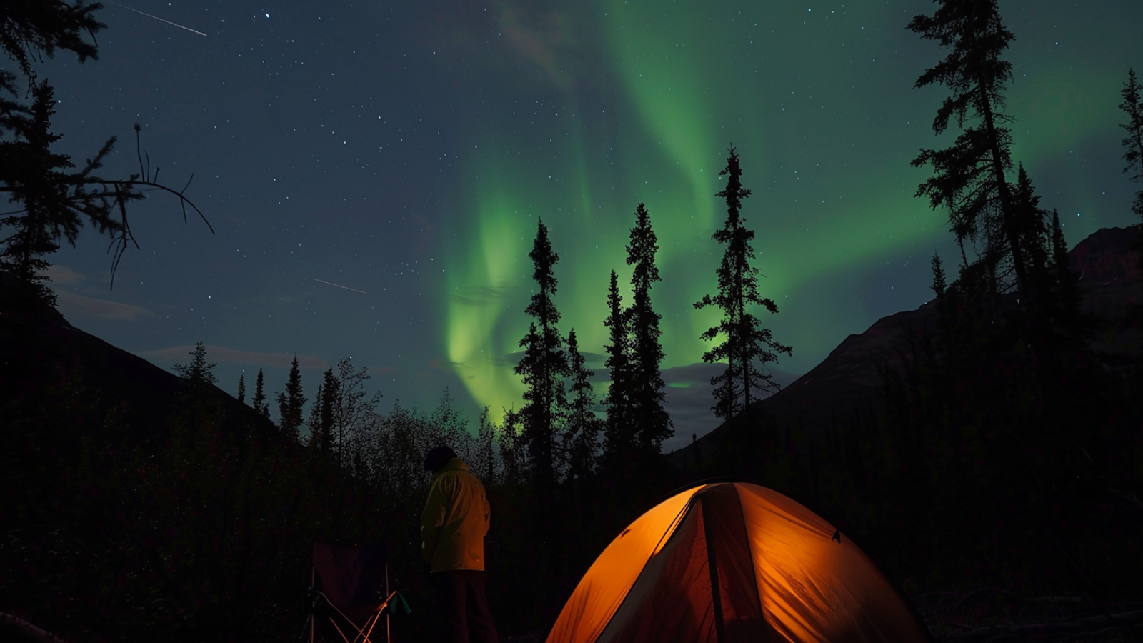 A tent pitched underneath the Northern Lights in Alaska