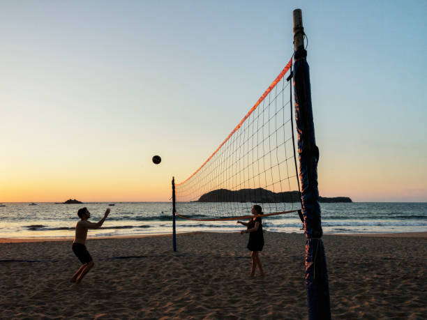 Play beach volleyball