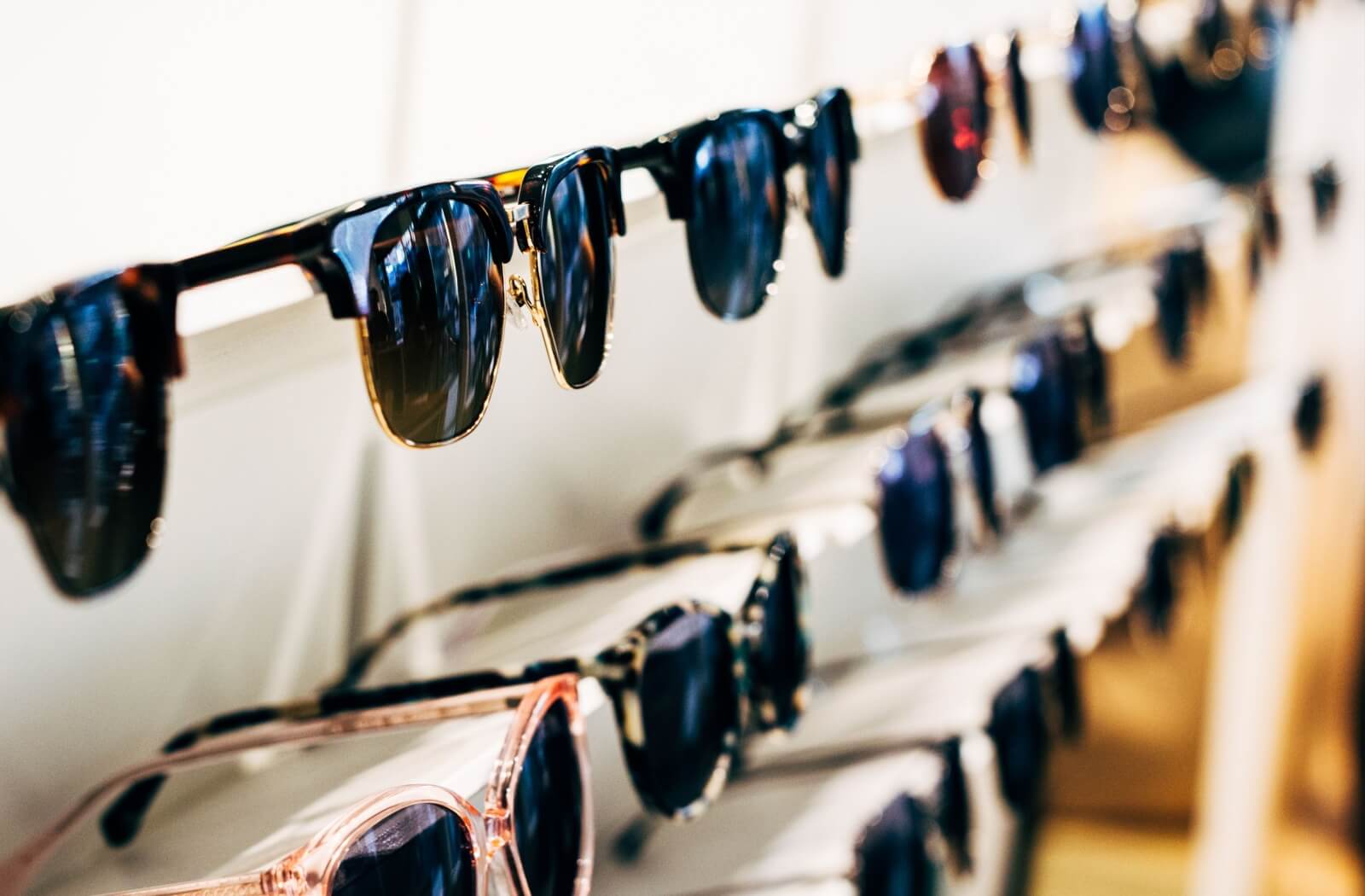 A display rack full of sunglasses to choose from.