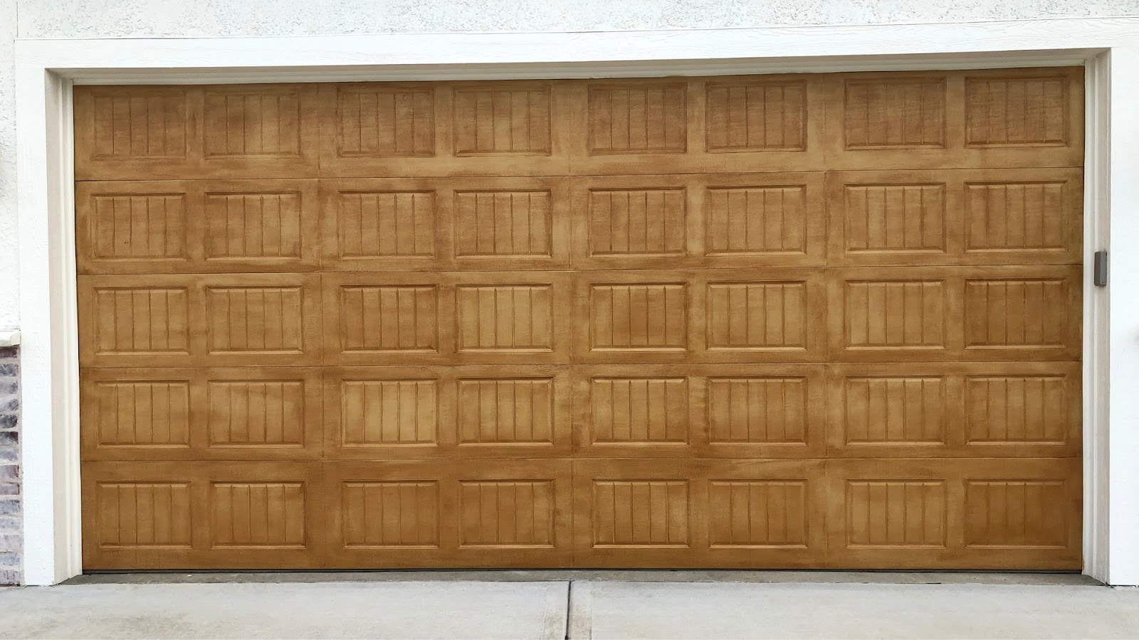 A wind-resistant garage door in faux wood finish
