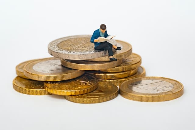 person sitting on coins