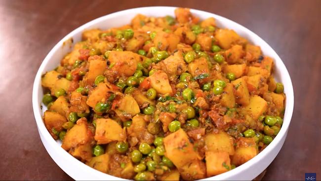 Finished Aloo Matar Ki Sabji garnished with fresh coriander leaves, served in a dish, ready to be enjoyed with roti or rice