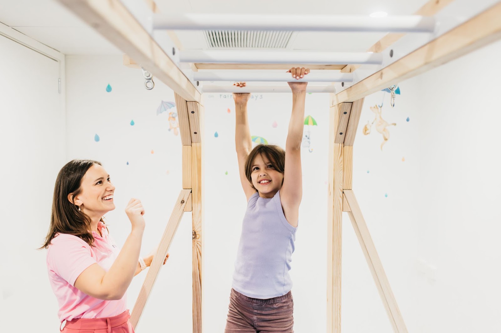 Child on the monkey bars in an OT session at billylids