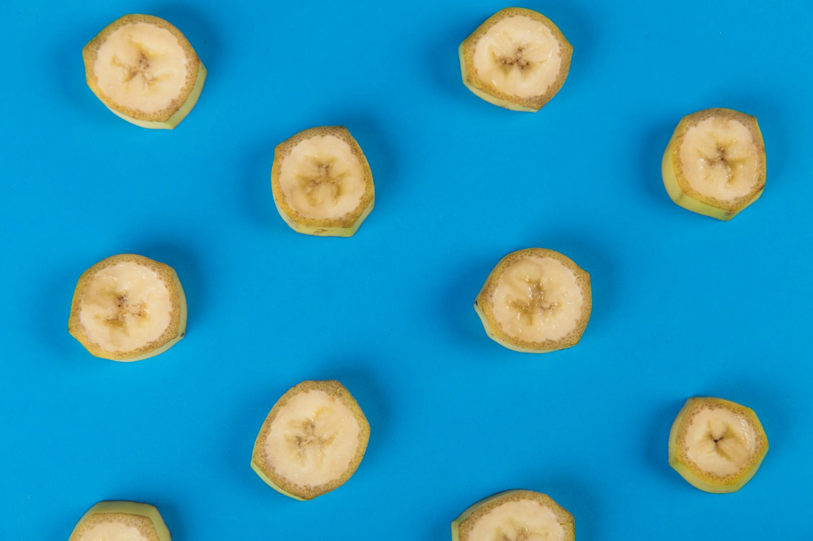 10 pieces of banana set randomly on a blue cover as the first identified superfood.