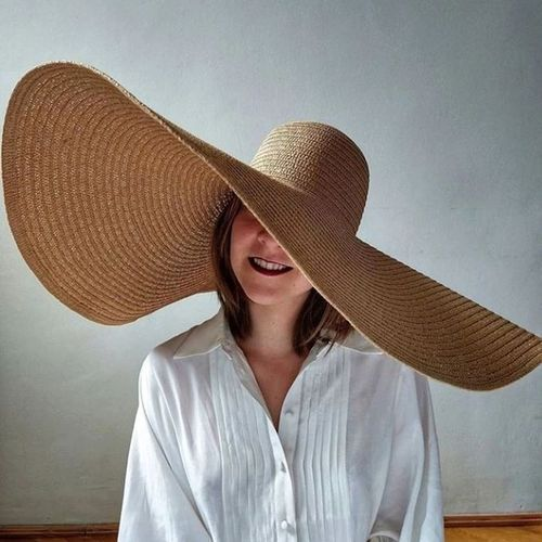 Types of Hat: Picture of a lady wearing the beach hat