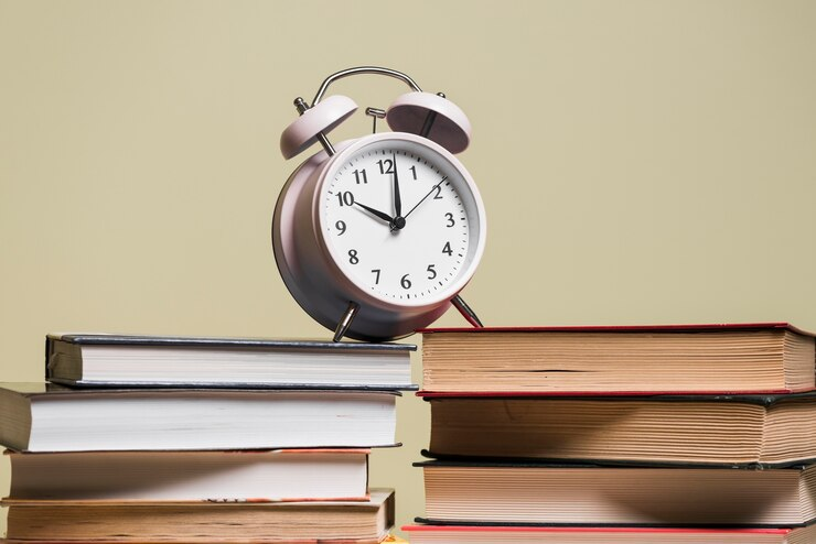 Alarm clock on a stack of books, symbolizing the importance of managing exam timing. 