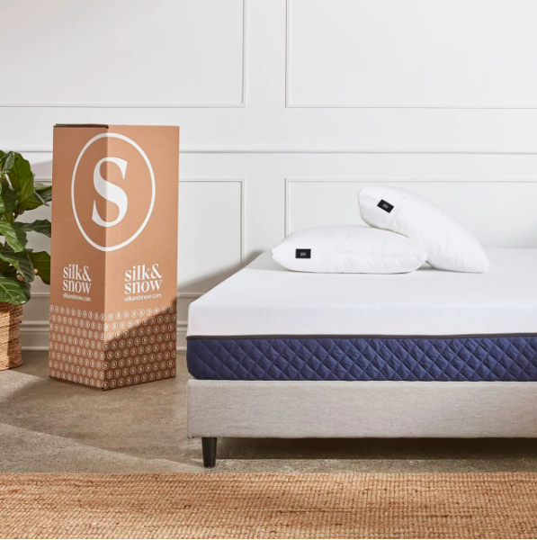 The S&S Mattress from Silk and Snow sitting on top of a gray bed frame