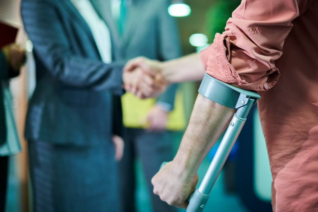 man with a crutch shaking a personal injury lawyers hand in spring hill florida