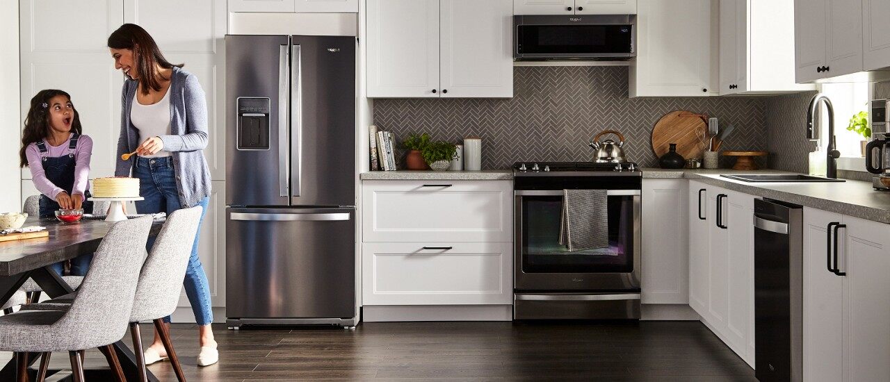 Mom and daughter in kitchen featuring Whirlpool® appliances 